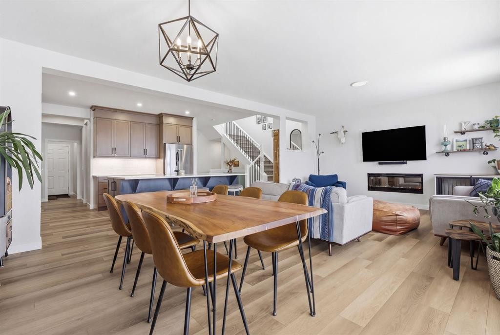 3 Sundown Crescent, Cochrane, AB - Indoor Photo Showing Dining Room With Fireplace