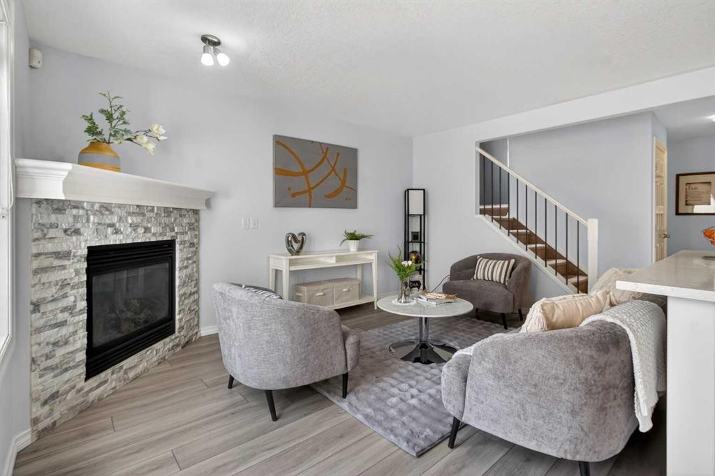 216 Royal Crest View Nw, Calgary, AB - Indoor Photo Showing Living Room With Fireplace