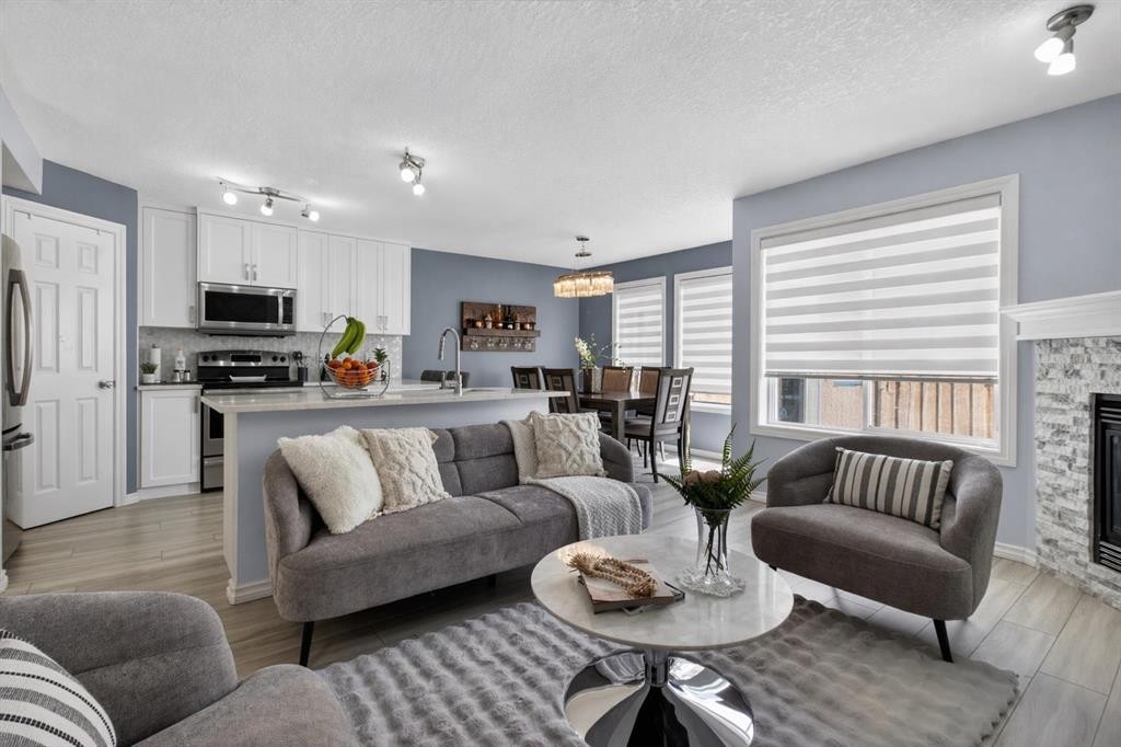 216 Royal Crest View Nw, Calgary, AB - Indoor Photo Showing Living Room With Fireplace