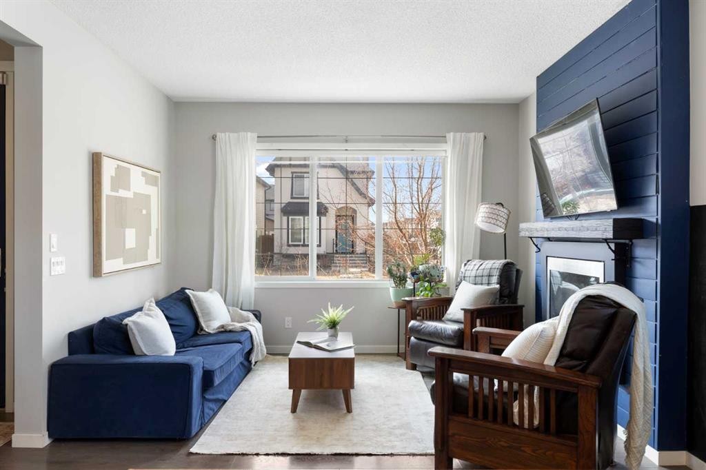 44 Marquis Link Se, Calgary, AB - Indoor Photo Showing Living Room With Fireplace