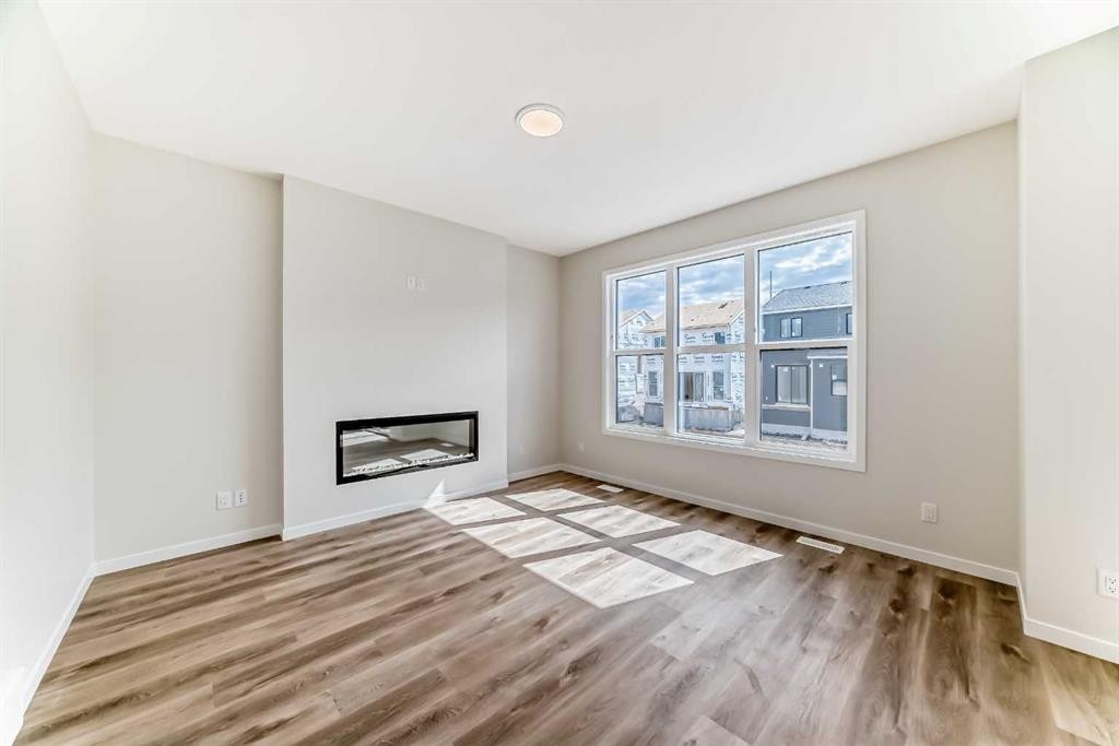 1069 Sawgrass Link Nw, Airdrie, AB - Indoor Photo Showing Living Room With Fireplace