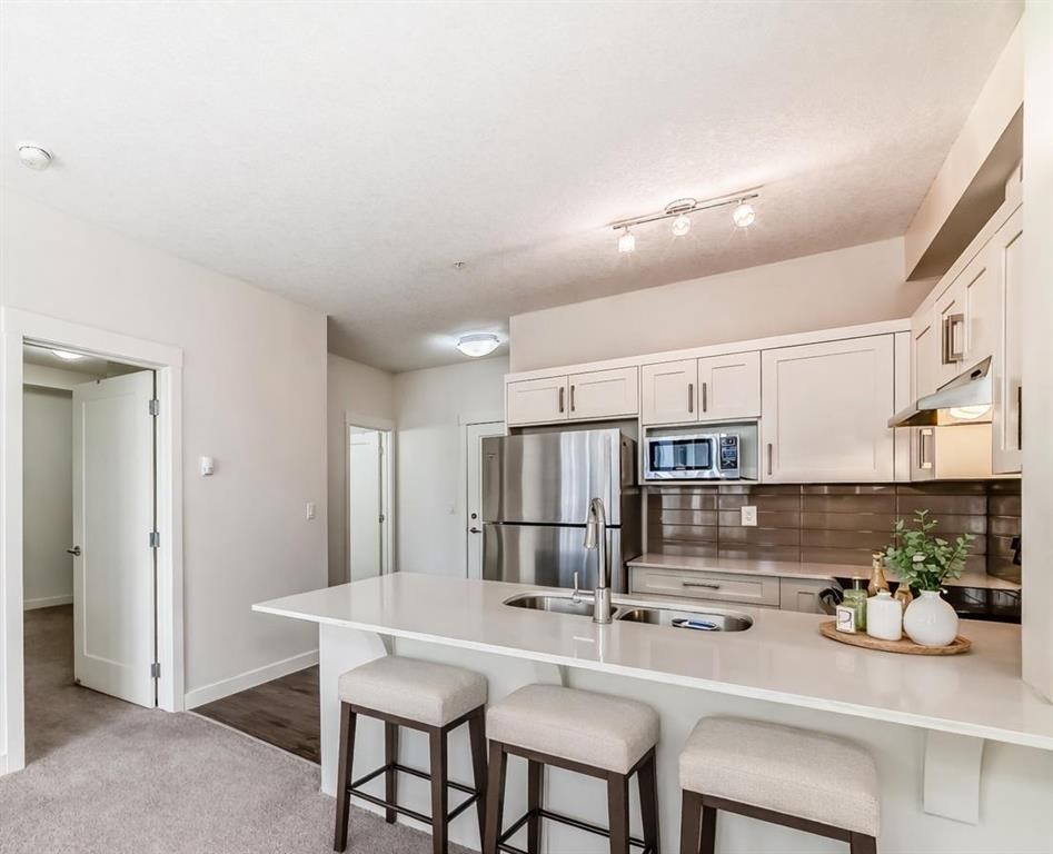 211-10 Walgrove Se, Calgary, AB - Indoor Photo Showing Kitchen With Stainless Steel Kitchen With Double Sink With Upgraded Kitchen