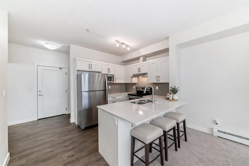 211-10 Walgrove Se, Calgary, AB - Indoor Photo Showing Kitchen With Stainless Steel Kitchen With Double Sink