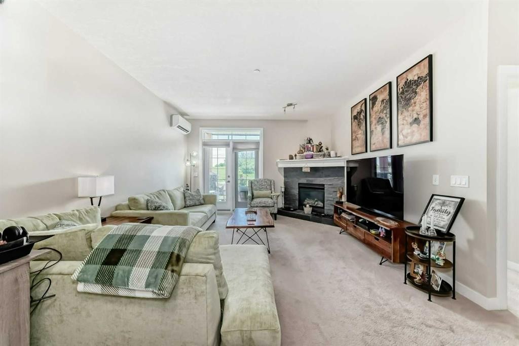 210-1005A Westmount Drive, Strathmore, AB - Indoor Photo Showing Living Room With Fireplace