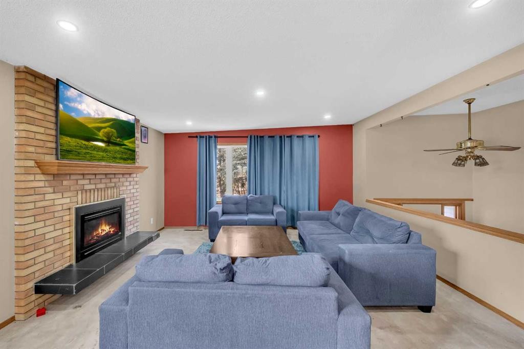 255192 Range Road 282, Delacour, AB - Indoor Photo Showing Living Room With Fireplace