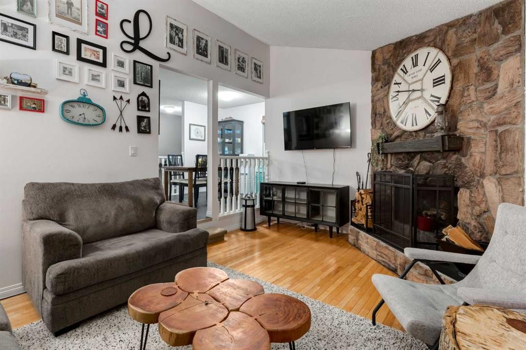 4 Cedarbrook Way Sw, Calgary, AB - Indoor Photo Showing Living Room With Fireplace
