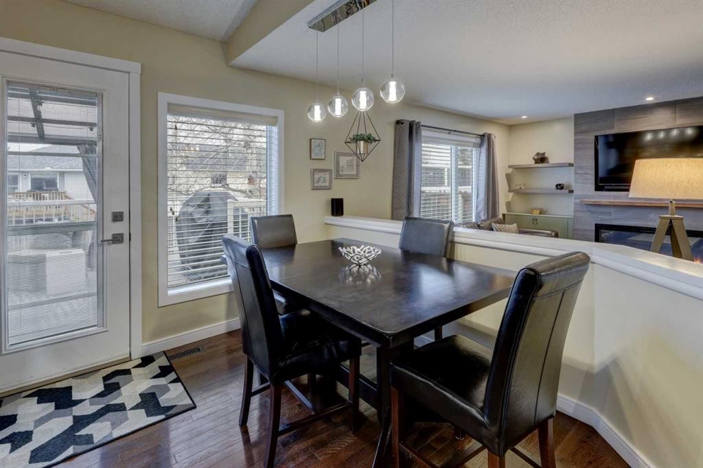 19 Riverstone Crescent Se, Calgary, AB - Indoor Photo Showing Dining Room With Fireplace