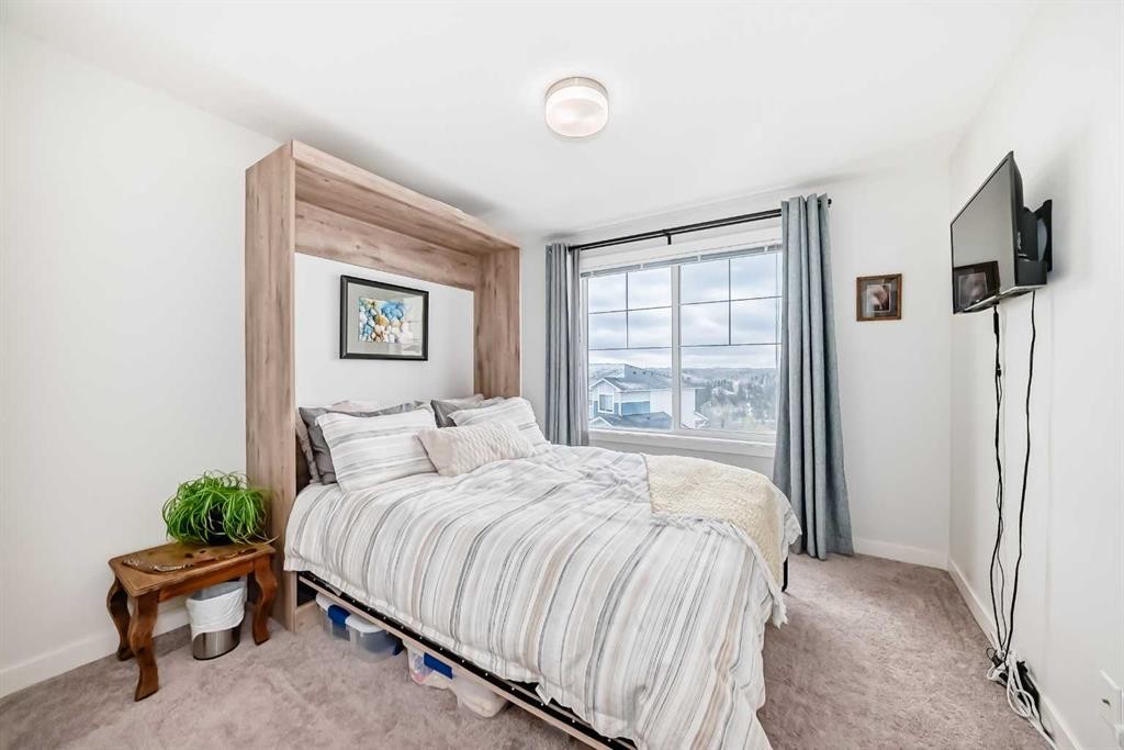 1302 Jumping Pound Common, Cochrane, AB - Indoor Photo Showing Bedroom