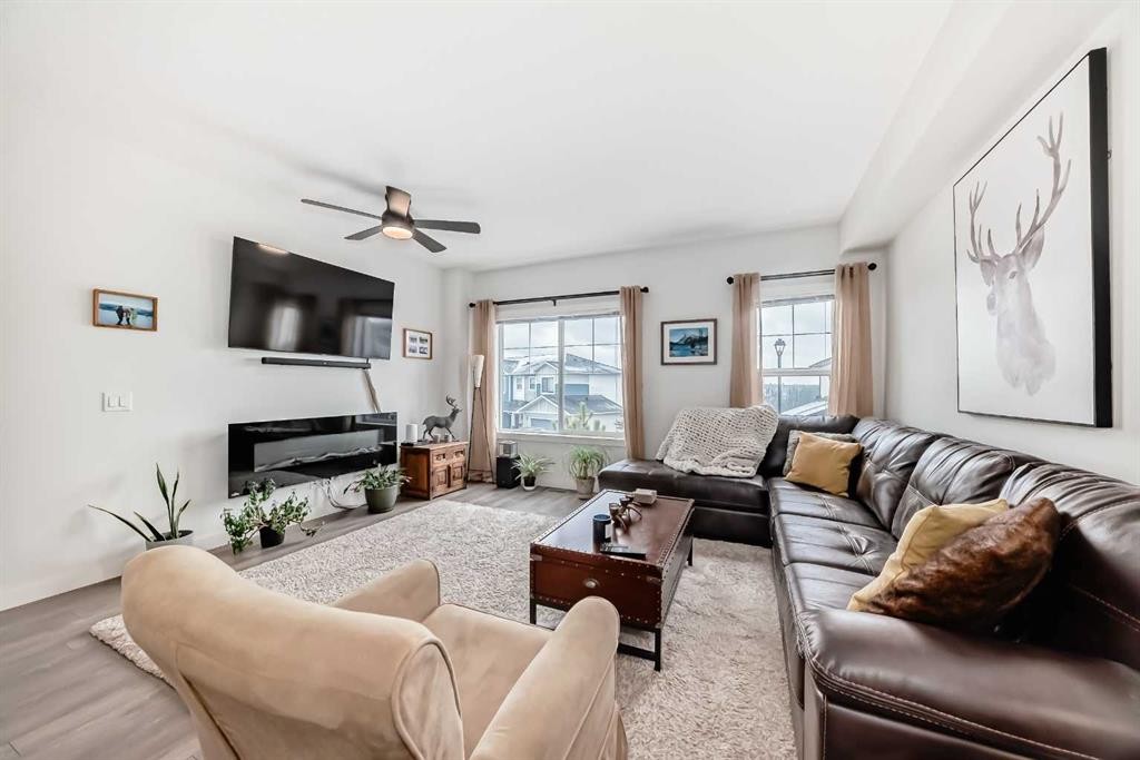 1302 Jumping Pound Common, Cochrane, AB - Indoor Photo Showing Living Room With Fireplace