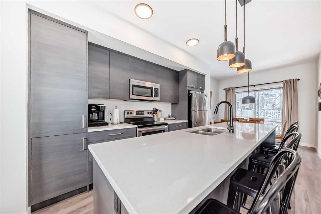 1302 Jumping Pound Common, Cochrane, AB - Indoor Photo Showing Kitchen With Double Sink With Upgraded Kitchen