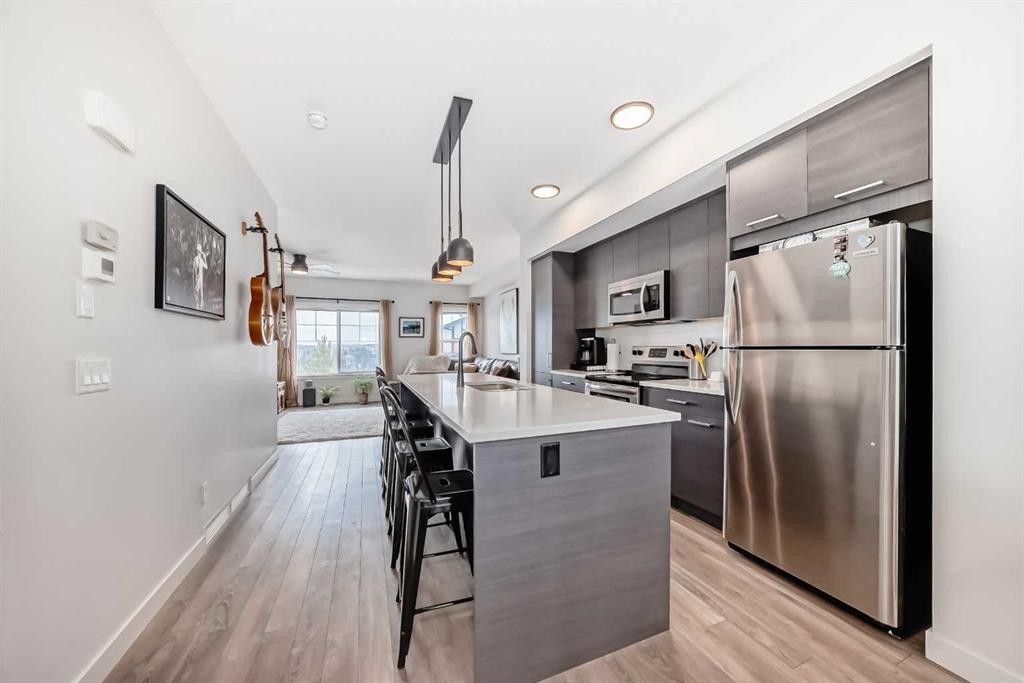 1302 Jumping Pound Common, Cochrane, AB - Indoor Photo Showing Kitchen With Upgraded Kitchen