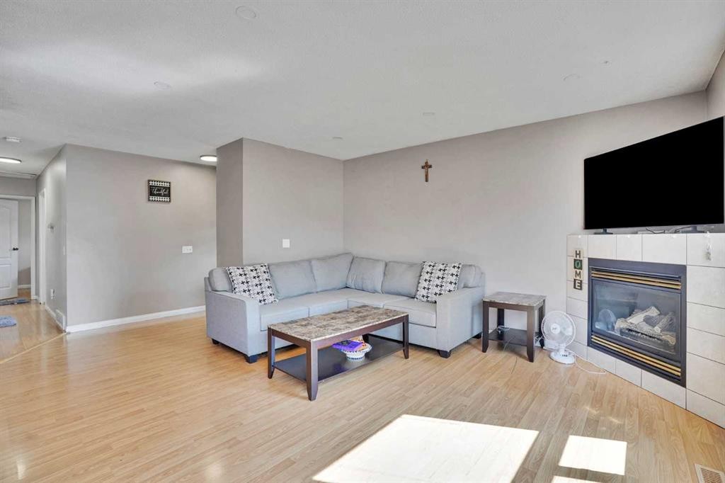 1004 Penrith Crescent Se, Calgary, AB - Indoor Photo Showing Living Room With Fireplace