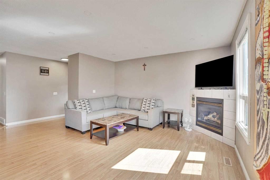 1004 Penrith Crescent Se, Calgary, AB - Indoor Photo Showing Living Room With Fireplace