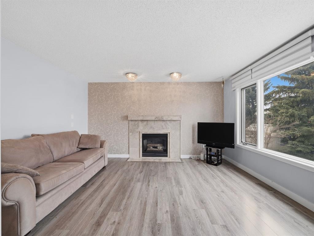 247 Hidden Valley Place Nw, Calgary, AB - Indoor Photo Showing Living Room With Fireplace
