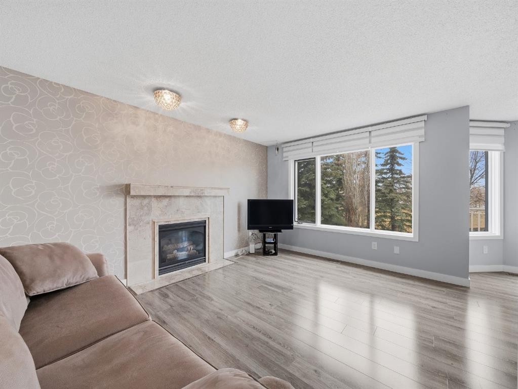 247 Hidden Valley Place Nw, Calgary, AB - Indoor Photo Showing Living Room With Fireplace