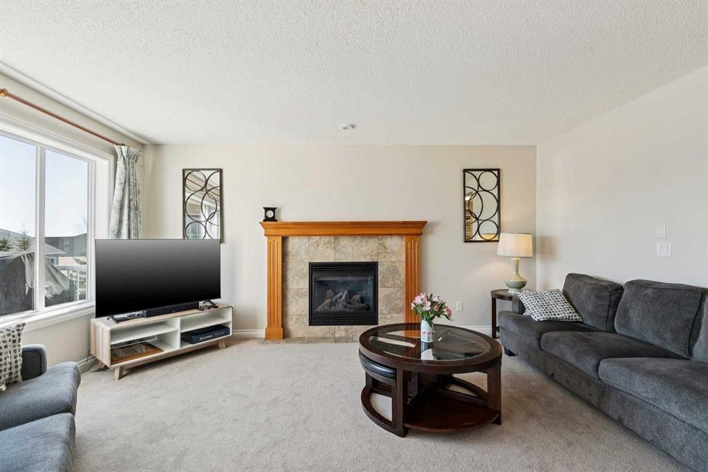 63 Westmount Circle, Okotoks, AB - Indoor Photo Showing Living Room With Fireplace