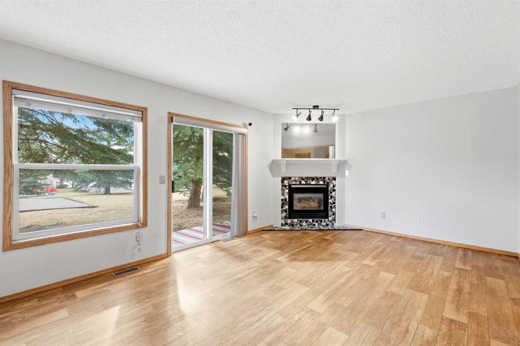 4B Millview Way Sw, Calgary, AB - Indoor Photo Showing Living Room With Fireplace