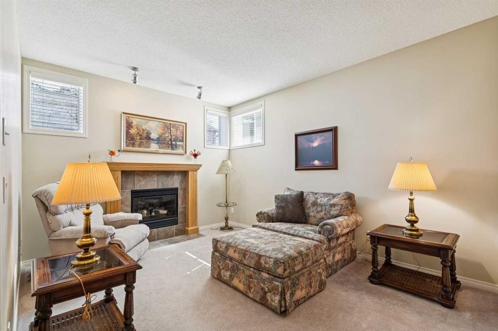 19 Wentworth Gardens Sw, Calgary, AB - Indoor Photo Showing Living Room With Fireplace