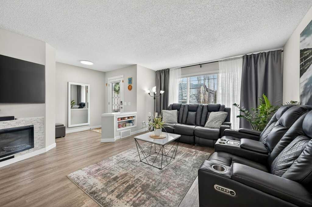 370 Prestwick Circle Se, Calgary, AB - Indoor Photo Showing Living Room With Fireplace