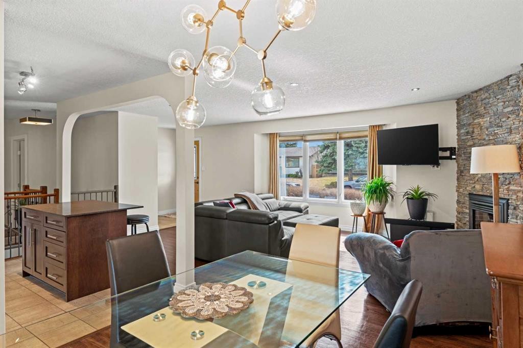 10311 Wapiti Drive Se, Calgary, AB - Indoor Photo Showing Dining Room With Fireplace