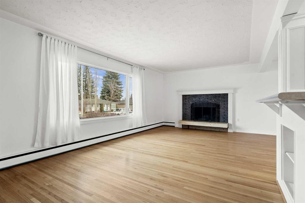 67 Hooke Road Sw, Calgary, AB - Indoor Photo Showing Living Room With Fireplace