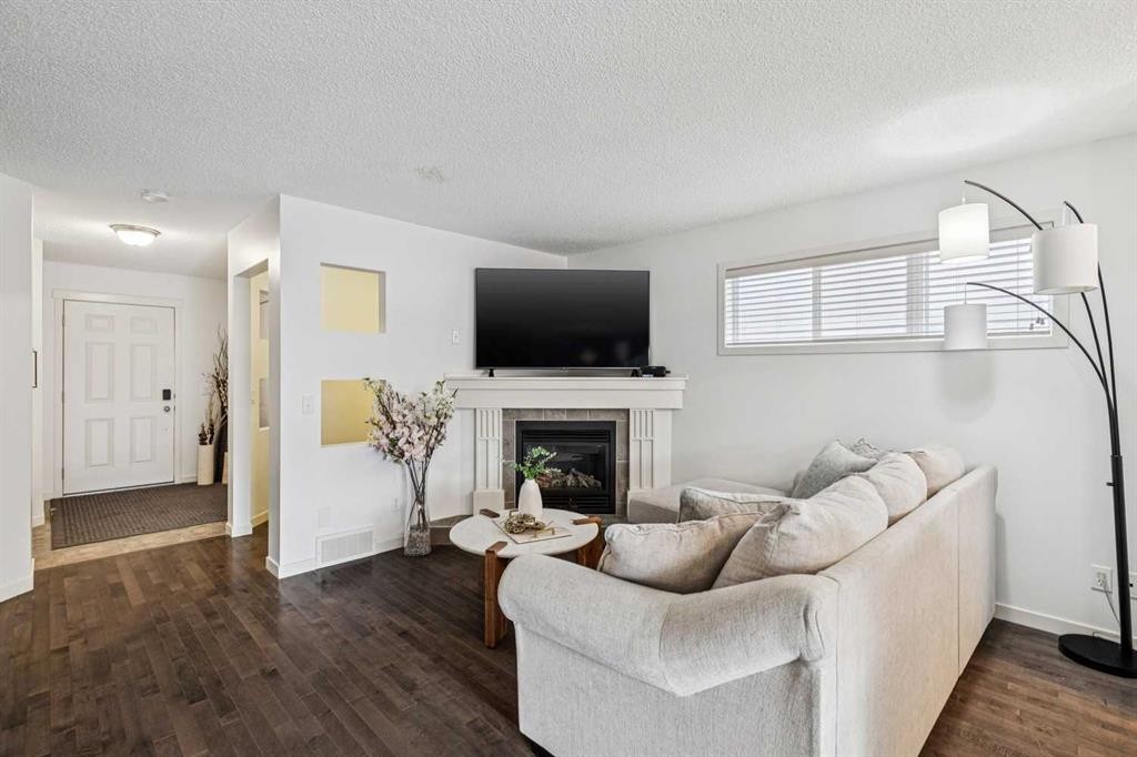 524 Cranston Drive Se, Calgary, AB - Indoor Photo Showing Living Room With Fireplace