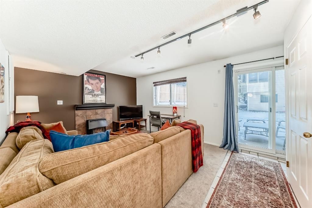 424 Hawkstone Manor Nw, Calgary, AB - Indoor Photo Showing Other Room With Fireplace
