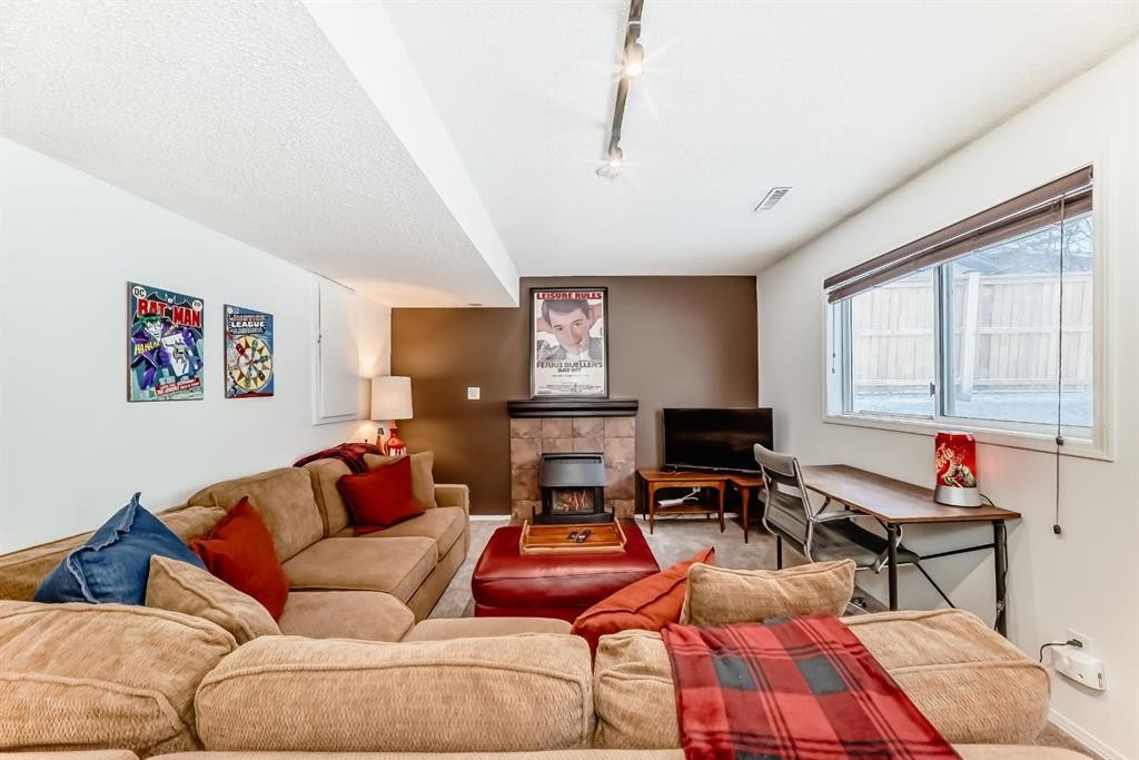 424 Hawkstone Manor Nw, Calgary, AB - Indoor Photo Showing Living Room With Fireplace