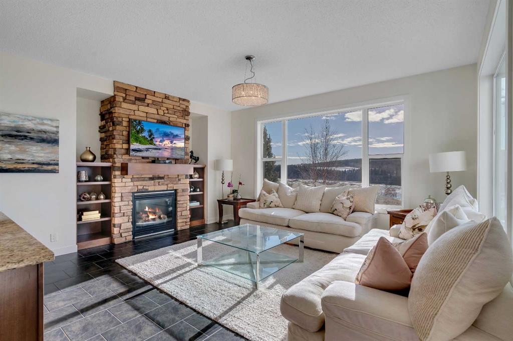 287 Sunset View, Cochrane, AB - Indoor Photo Showing Living Room With Fireplace