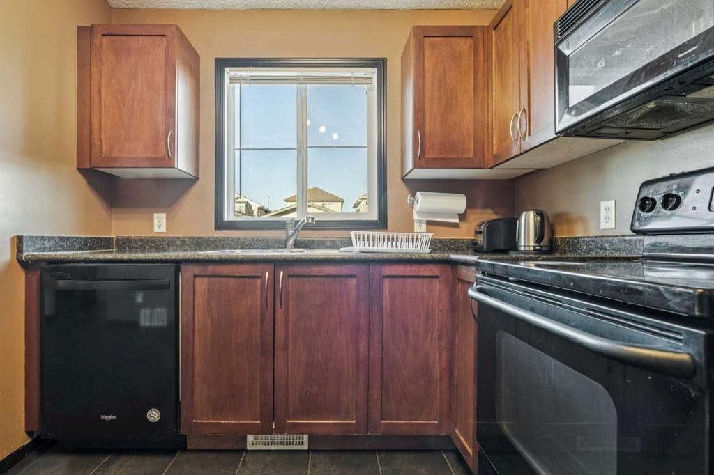 110 Eversyde Common Sw, Calgary, AB - Indoor Photo Showing Kitchen With Double Sink