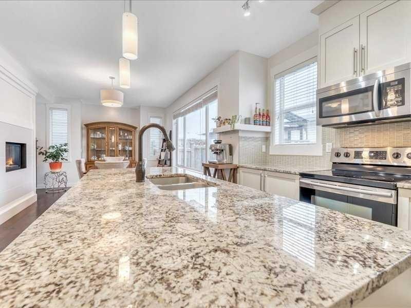 201 Rainbow Falls Glen, Chestermere, AB - Indoor Photo Showing Kitchen With Fireplace With Stainless Steel Kitchen With Double Sink With Upgraded Kitchen