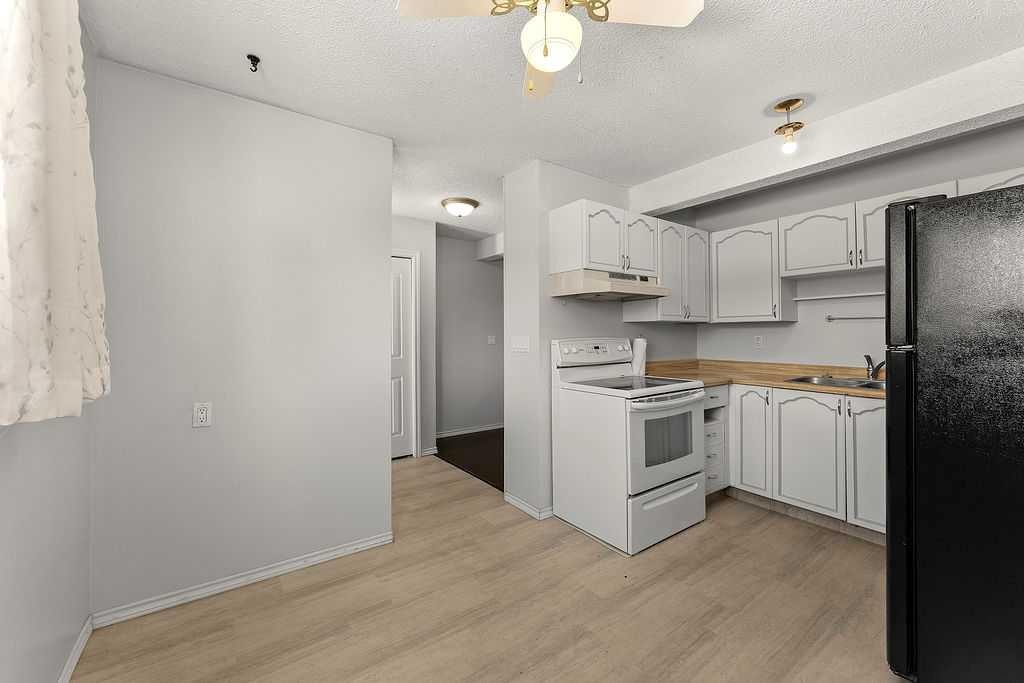 56-5520 1 Avenue Se, Calgary, AB - Indoor Photo Showing Kitchen With Double Sink