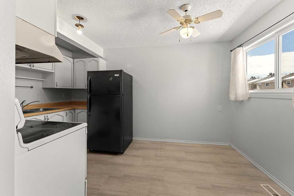 56-5520 1 Avenue Se, Calgary, AB - Indoor Photo Showing Kitchen With Double Sink
