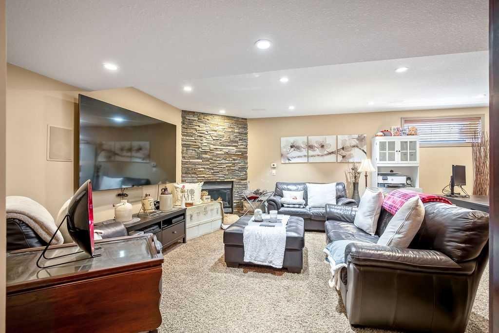 49 Spring Meadows Bay, Okotoks, AB - Indoor Photo Showing Living Room With Fireplace
