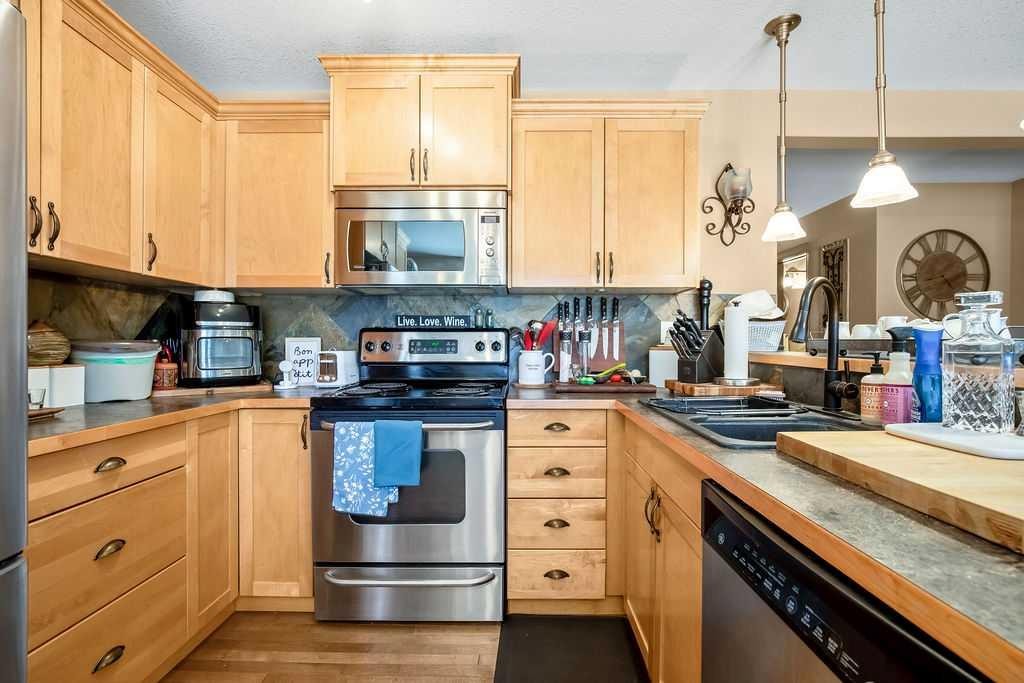 49 Spring Meadows Bay, Okotoks, AB - Indoor Photo Showing Kitchen With Stainless Steel Kitchen With Double Sink