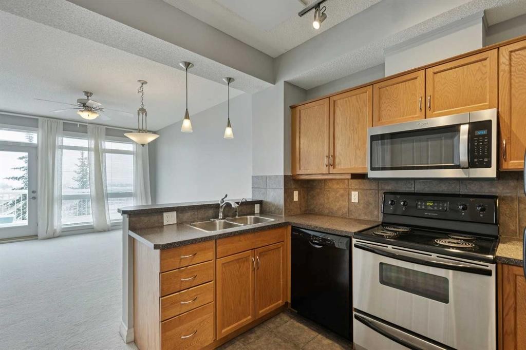 14-133 Rockyledge View Nw, Calgary, AB - Indoor Photo Showing Kitchen With Double Sink
