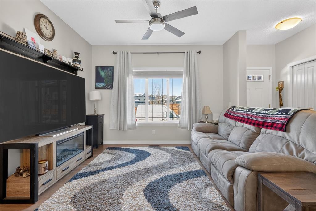 23 Belgian Link, Cochrane, AB - Indoor Photo Showing Living Room With Fireplace