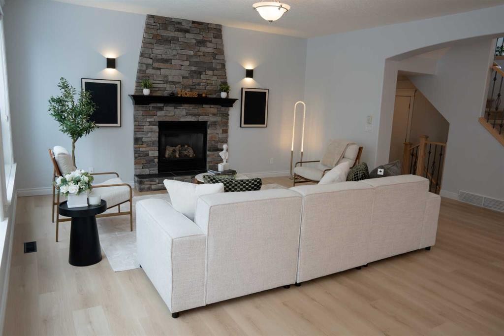 3 Strathridge Bay Sw, Calgary, AB - Indoor Photo Showing Living Room With Fireplace