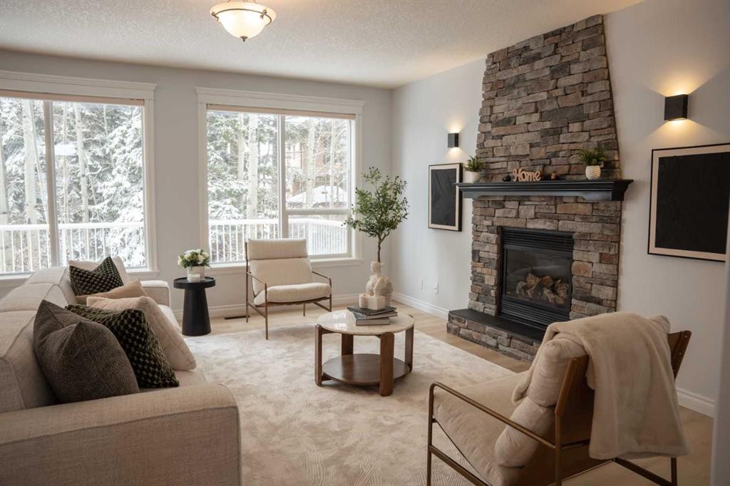 3 Strathridge Bay Sw, Calgary, AB - Indoor Photo Showing Living Room With Fireplace