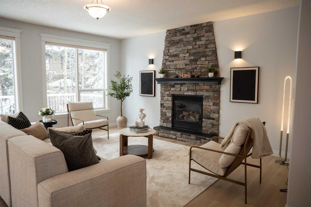 3 Strathridge Bay Sw, Calgary, AB - Indoor Photo Showing Living Room With Fireplace