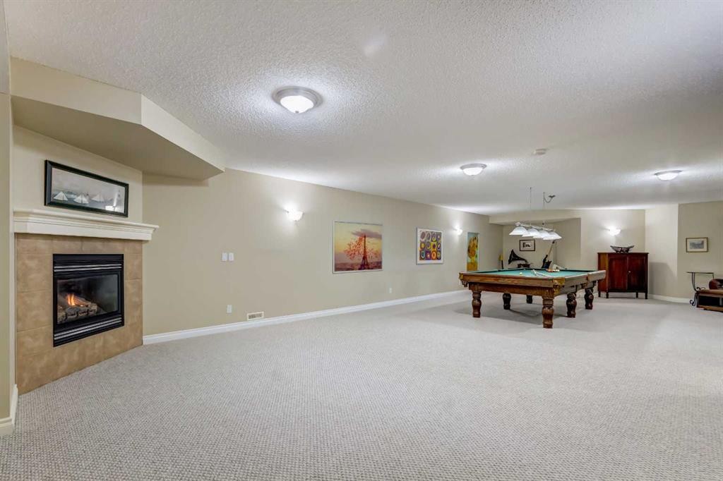8 Straddock Villas Sw, Calgary, AB - Indoor With Fireplace
