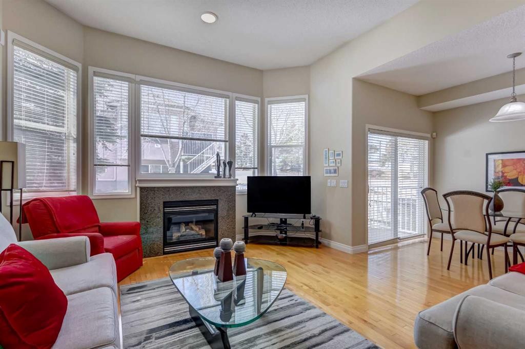 8 Straddock Villas Sw, Calgary, AB - Indoor Photo Showing Living Room With Fireplace
