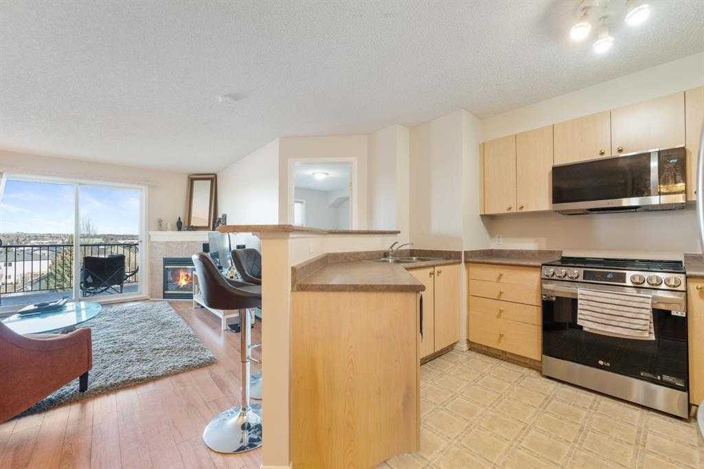 1406-12 Cimarron Common, Okotoks, AB - Indoor Photo Showing Kitchen With Double Sink