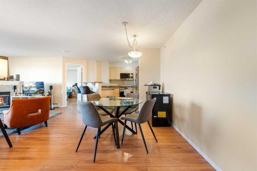 1406-12 Cimarron Common, Okotoks, AB - Indoor Photo Showing Dining Room With Fireplace