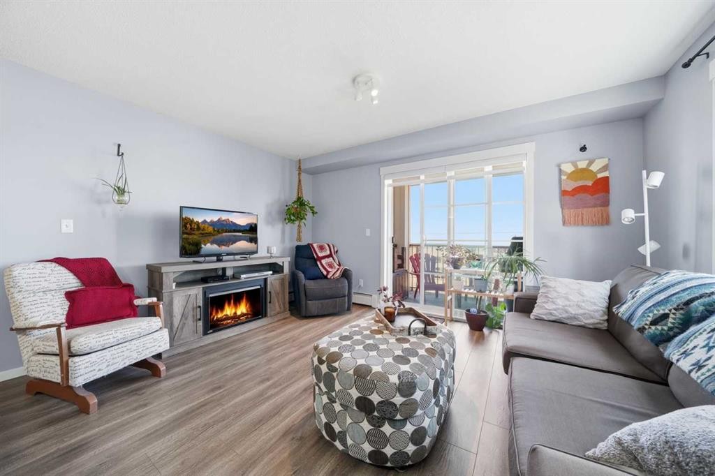 4201-279 Copperpond Common Se, Calgary, AB - Indoor Photo Showing Living Room With Fireplace