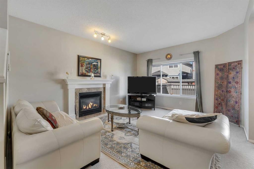 149 Saddlecrest Green Ne, Calgary, AB - Indoor Photo Showing Living Room With Fireplace