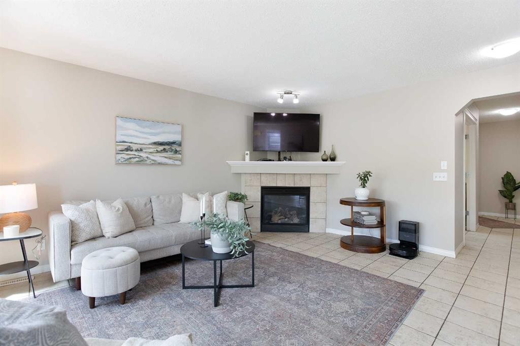 403 Morningside Way Sw, Airdrie, AB - Indoor Photo Showing Living Room With Fireplace