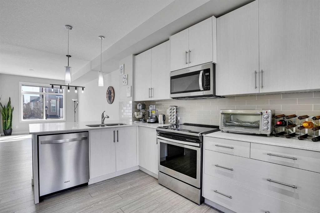 104 Legacy Path Se, Calgary, AB - Indoor Photo Showing Kitchen With Stainless Steel Kitchen With Double Sink With Upgraded Kitchen