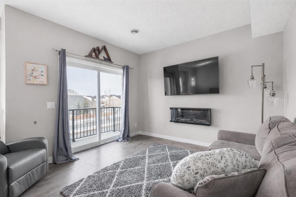 811-250 Fireside View, Cochrane, AB - Indoor Photo Showing Living Room With Fireplace