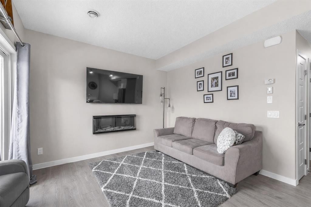 811-250 Fireside View, Cochrane, AB - Indoor Photo Showing Living Room With Fireplace